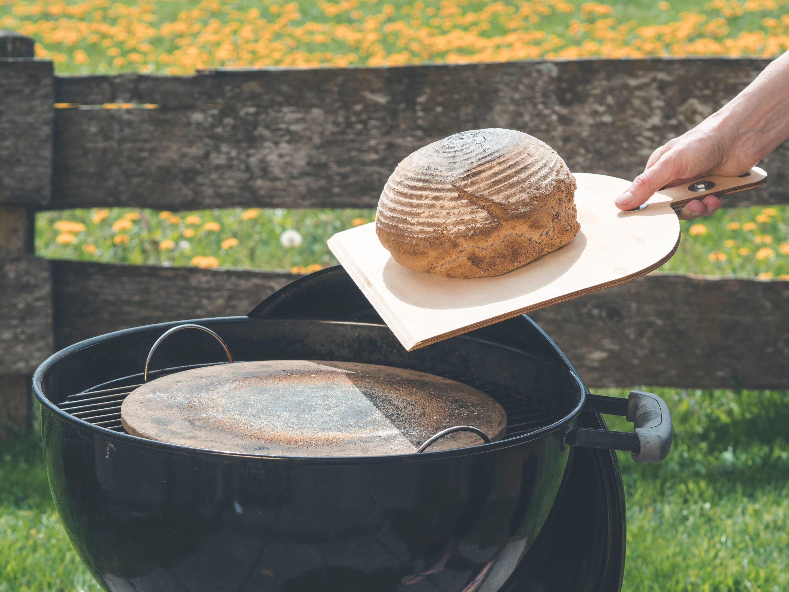 person baking bread on BBQ