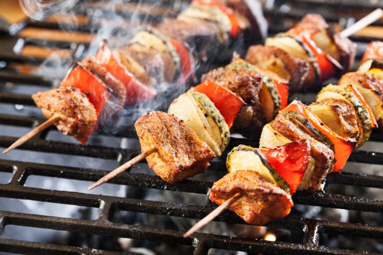 A picture of BBQ skewers being grilled
