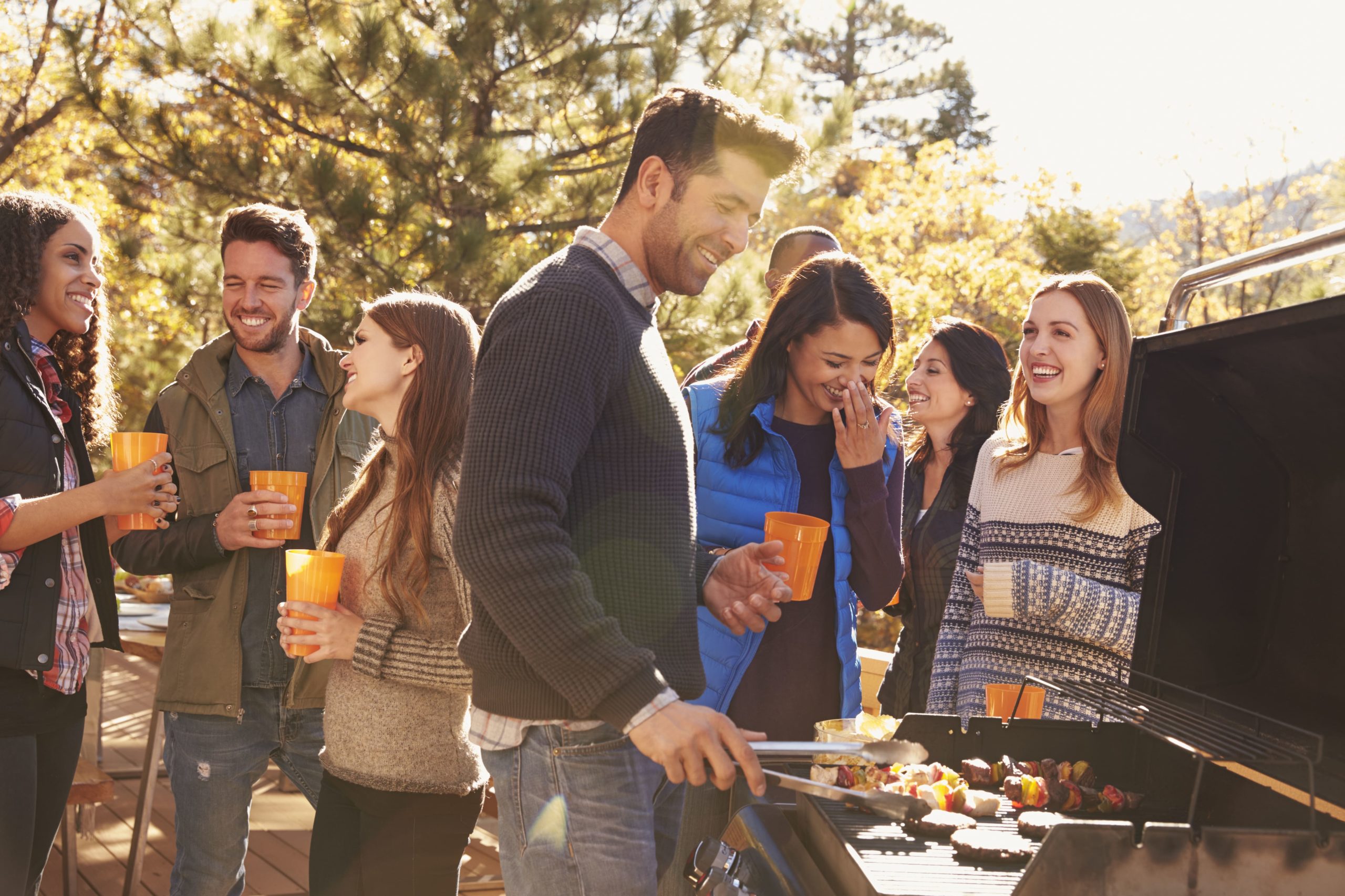 group of friends enjoying an autumn fall BBQ together