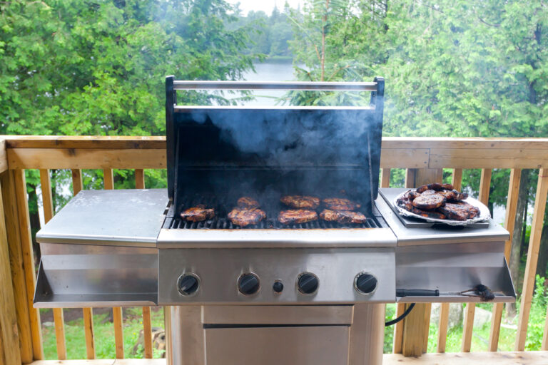 A picture of a BBQ with the lid left open.